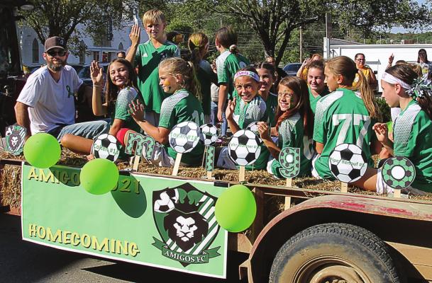 MEMBERS of the Amigas and Amigos FC soccer teams participate in the Excelsior Springs High School Homecoming Parade downtown Saturday. J.C. VENTIMIGLIA | Staff