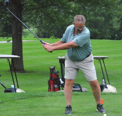 LONGTIME COACH Gregg Williams keeps his head down as he tees off to help get the tournament for his foundation started.