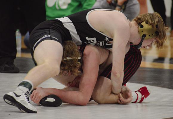 COOPER COLLINS (top), shown wrestling in a title match at Class 2 District 4 competition, has a state medal to show for this season, as do Justin Wright, Ryne Marcum and Logan Bates. SHAWN RONEY | Staff