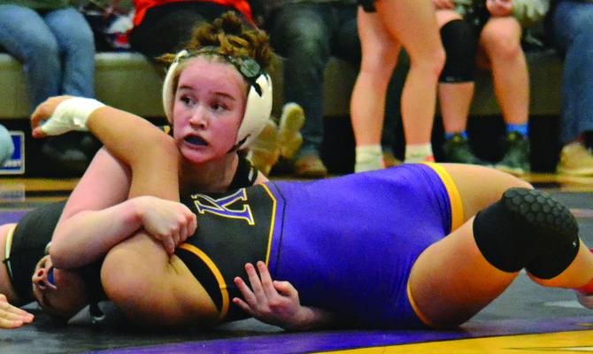 LILLY GOETZ (top) ends the first period of her 120-pound Class 1 District 4 Tournament semifinal match with Kearney’s Riley Walker with a near fall. She goes on to win by a third-period pin, securing her place at state. DUSTIN DANNER | Staff