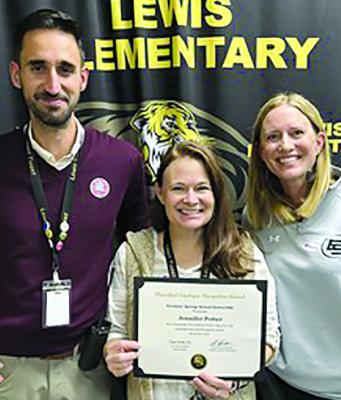 LEWIS ELEMENTARY Principal Dr. Jill Comstock (right) and Assistant Principal Bryson Travis (left) present Administrative Assistant Jennifer Potter with the Certified Employee of the Month award. | Submitted