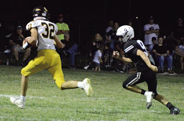 WITH THE FOOTBALL tucked into his left arm, Orrick sophomore Malachi Fletcher pulls away from Norborn Hardin-Central’s Brody Fifer for a fourth-quarter touchdown. Trailing 20-0 at halftime, Fletcher and his fellow Bearcats vainly try to catch the Aggies the second half, falling 46-20 Sept. 20 in varsity 8-man football action at Hardin-Central. SHAWN RONEY | Staff
