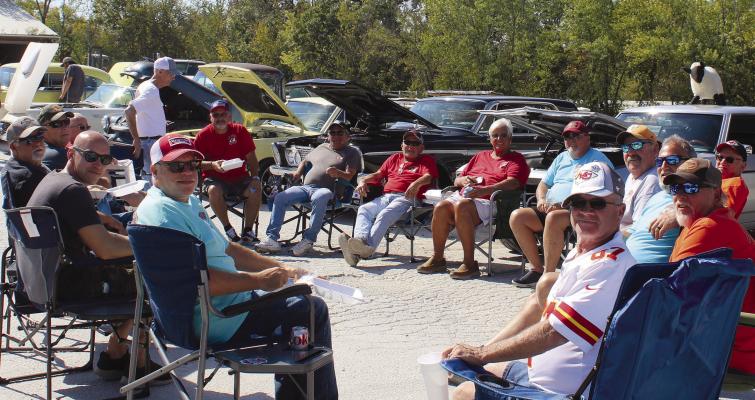 ROOSTER’S CLUB members sit and chat during the car show. MIRANDA JAMISON | Staff