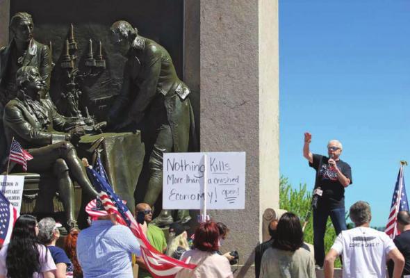 RADIO SHOW host Dave “Super Dave” Day warms up the Reopen Missouri crowd of about 1,000 on the Capitol grounds. Many carry signs denouncing Gov. Mike Parson’s stay-home order. J.C. VENTIMIGLIA | Staff