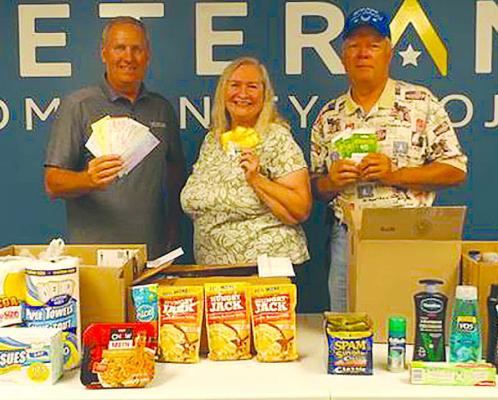 CHRIS ADMIRE (from left) accepted donations from OCC members Barbara and Mike Britt. Submitted