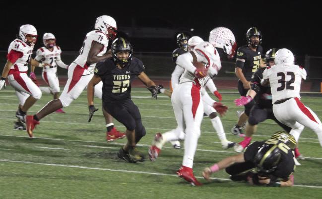 JUNIOR DOMINICK ROGERS breaks down to attempt to make a tackle for Excelsior Springs against Raytown South Oct. 13 at Tiger Stadium. MIRANDA JAMISON | Staff