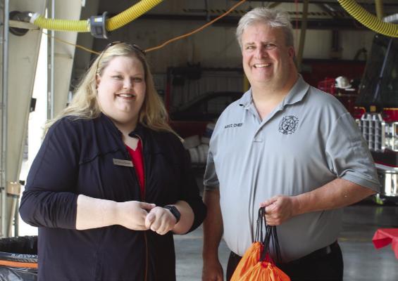 EXCELSIOR SPRINGS Animal Clinic Associate Veterinarian Erica Nowlin (left) stands with Excelsior Springs Fire Department Assistant Chief Brad Smith with pet oxygen masks. This donation was made possible through a statewide project that aims to ensure the health of animals. MIRANDA JAMISON | Staff
