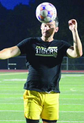 EXCELSIOR SPRINGS VARSITY COACH Brett McKenzie demonstrates the way he wants his boys soccer players to head the ball. SHAWN RONEY | Staff