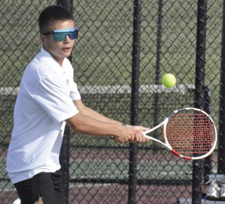 AIDEN O’DELL looks to hit a two-fisted backhand shot during Excelsior Springs’ varsity tennis dual with Lafayette County of Higginsville. SHAWN RONEY | Staff