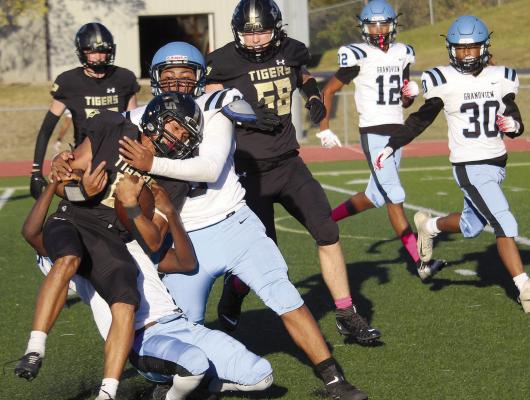 MARQUES SHOUSE fights a tackle from the Grandview Bulldogs. MIRANDA JAMISON | Staff