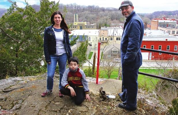 THE RADECKI family closes on the old Hotel Castle Rock property in downtown Excelsior Springs. From left are Krissy, Riley and Ryan Radecki, who reveal that their business plan for “the hill” includes creating an apiary by summer, with a possible conservatory and food stand for the future. J.C. VENTIMIGLIA | Staff