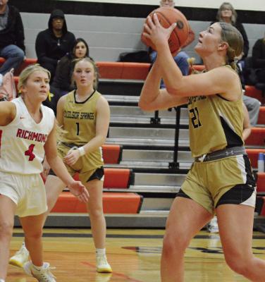 BELLA LOEFFERT takes aim to shoot as (from left) Ella Steele and Kayden Rogers watch during district basketball action. More game photos on page 8. SHAWN RONEY | Staff