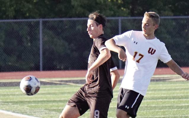 EXCELSIOR SPRINGS sophomore Grayson Grove battles to gain control of the ball Sept. 12 against Winnetonka. DUSTIN DANNER | Staff