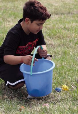 MICHAEL CRUZ scoops up another discovery while making his way across the field. MIRANDA JAMISON | Staff