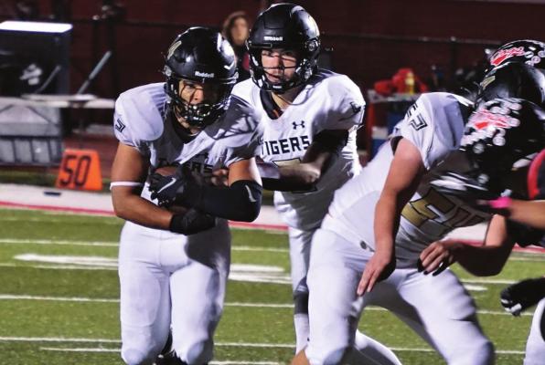 CLUTCHING THE FOOTBALL with both hands, senior running back Lukas Shelton gets around the corner and looks for more yardage during Excelsior Springs’ Oct. 16 road win over Odessa. DUSTIN DANNER | Staff