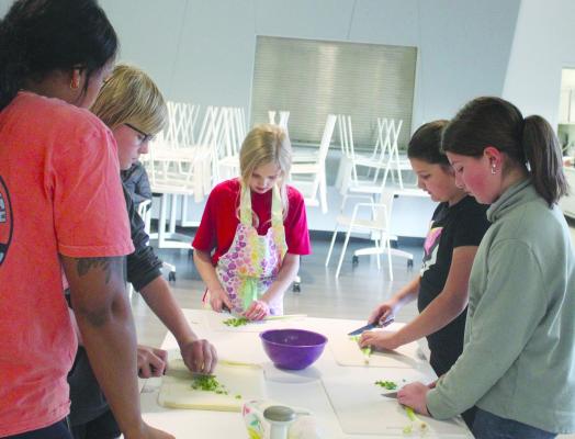 Community Center teaches kids how to chop vegetables