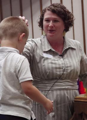 PASTOR SHANNON GREENE blesses a child during a baptism service at First United Methodist Church. Submitted