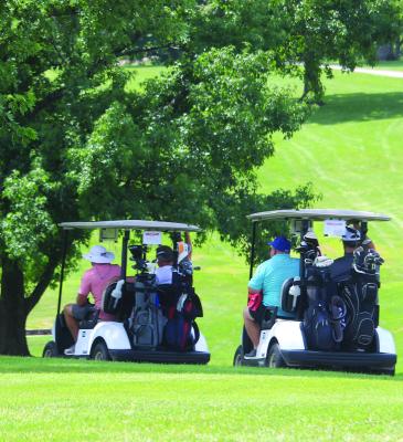 MIRANDA JAMISON | Staff GOLFERS DRIVE their carts to their assigned holes and wait for the event to begin.
