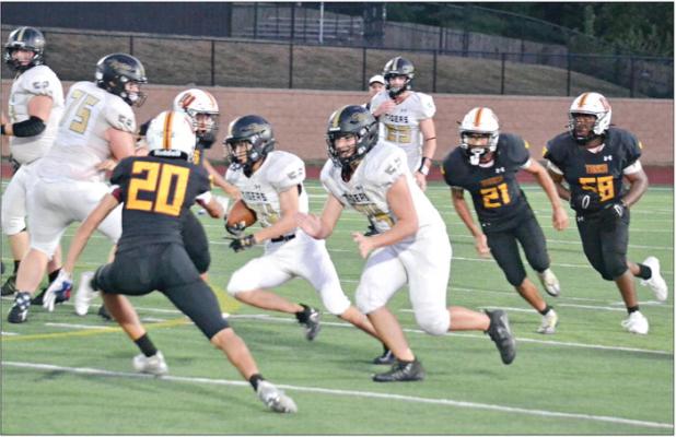 WITH THE BALL under his right arm, sophomore Gage Carr heads through a hole for a big gain during the Tigers’ 35-7 Week 3 road loss to Winnetonka. DUSTIN DANNER | Staff