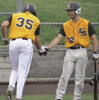 BRODY QUERRY (left) gets a low five from Carter Smith after scoring during Excelsior Springs’ Senior Night win over Belton. SHAWN RONEY | Staff