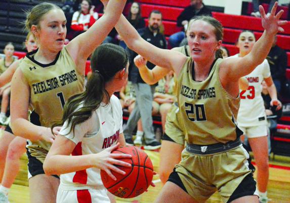 KAYDEN ROGERS (left) and Kinley Rogers attempt a trap during Excelsior Springs’ fifth-place game with Richmond at the Lawson Invitational. SHAWN RONEY | Staff