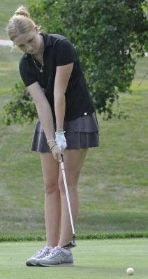 ELLA EDWARDS, an Excelsior Springs junior, watches a putt attempt while she’s on the links. SHAWN RONEY | Staff
