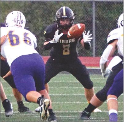 EXCELSIOR SPRINGS running back Rhys Guthrie takes a snap in the wildcat formation during the Tigers’ Sept. 15 meeting with visiting Kearney in Greater Kansas City Suburban Conference-Blue Division action. TIM HARLAN | Submitted