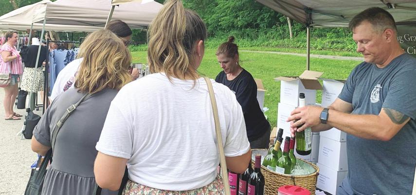 CLETIS AND AMY WEBB serve wine from Giggling Grapes Winery. They are among 20 Missouri wineries attending.