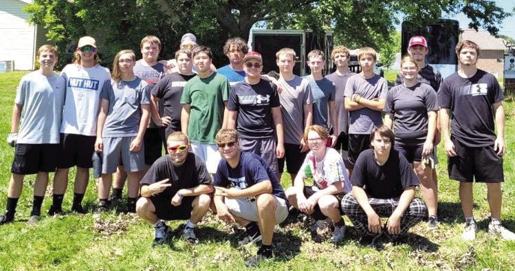 ESHS FOOTBALL teammates gather July 13 for a day of community service, helping 18 families and businesses during the annual Tiger Service Day.