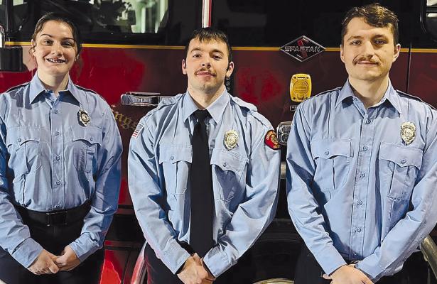 FIREFIGHTER AND EMT Emily Rice (left), Firefighter and Paramedic Camden Dickey, and Firefighter and EMT Joseph Cherco are honored during a badge pinning ceremony after finishing their probationary periods with the Excelsior Springs Fire Department. Submitted