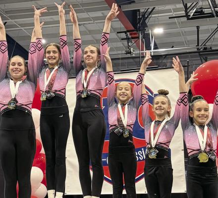 SARAH HOWERTON (from left), Bailey Myers-O’Dell, Madi Ray, Jacqueline Wood, Olive Behler and Summer Lawson celebrate the Northwest Gymnastics Xcel Platinum team’s first-place win at the KC Coed Classic. NORTHWEST GYMNASTICS | Submitted