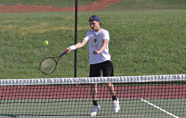 AUSTIN COLLINS also approaches the net during the April 17 dual with Richmond, returning a shot for a point during the Tigers’ home victory. DUSTIN DANNER | Staff