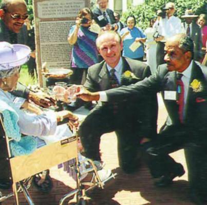 TO DEDICATE the Freedom Fountain on Liberty Square in 2001, Lulu Johnson Fielder, 102, toasts with water from the fountain with area leaders and, opposite from her, Gov. Bob Holden. MARK COFFEY | 2001