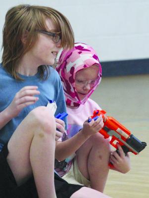 LIAM AND LILLY HELMS strategize together before jumping back into the action.