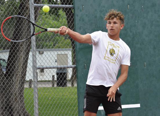 CARTER PITTS hits a forehand shot during his Class 1 sectional singles match with Felix De Hesselle of Richmond May 12 at Maurice Roberts Park in Richmond. The match takes place a few hours before Pitts’ graduation. SHAWN RONEY | Staff