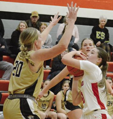KINLEY ROGERS (left) contests Adilyn Swope’s drive to the bucket during Excelsior Springs’ Class 4 District 14 Tournament nail-biter with Richmond. Swope, a sophomore, would later lead the Spartans on an ill-fated attempt at staging a last-minute comeback victory.