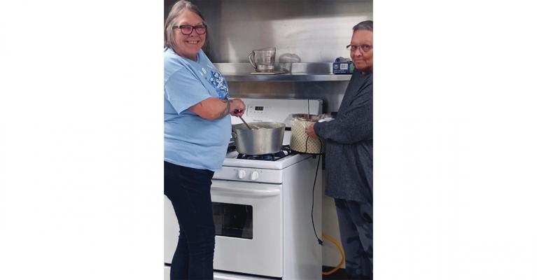 THE TEAM of Denise Rainey and Diana Bernard cook for community members at the Good Samaritan Center in Excelsior Springs.
