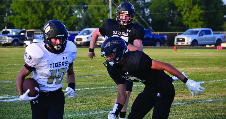 DAITON LOVE carries the ball during the Tigers’ 33-21 win Aug. 28 at Savannah. The Tigers later learn a Savannah player has COVID-19.