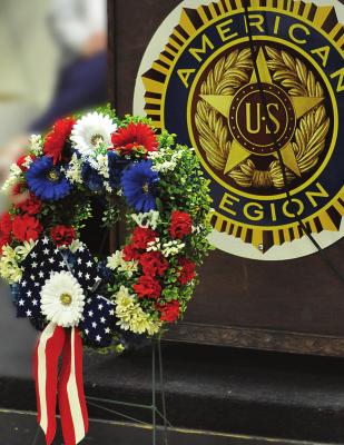THE FIRST commemorative wreath is placed in front of the stage for Memorial Day in Excelsior Springs. Other wreaths are placed to honor fallen members of the Army, Navy, Air Force, Marine Corps, Coast Guard and Merchant Marine. The Veterans Administration has granted veteran status to Merchant Mariners who served during World War II. Find more event photos on Page 10. SHAWN RONEY | Staff