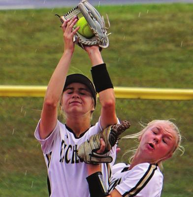 SENIOR JORDYN PEKREK and freshman Alyssa Dean collide but make the play on a fly ball. TIM HARLAN | Submitted Photo
