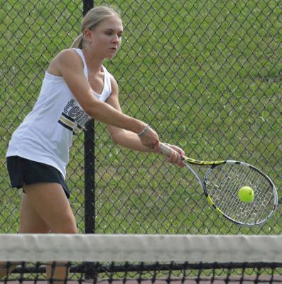 ALICJA JAROSZ, an exchange student from Poland, watches the ball as she hits a two-fisted backhand for Excelsior Springs during her No. 1 singles title match. SHAWN RONEY | Staff