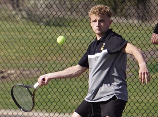 AUSTIN COLLINS hits a forehand shot during Excelsior Springs’ varsity boys tennis dual with Benton of St. Joseph. DUSTIN DANNER | Staff