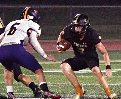 CARSON JACKSON (No. 3) attempts to cut back and find a hole where he can run during Excelsior Springs’ 42-20 season-opening loss to Belton Aug. 25 at Tiger Stadium. TIM HARLAN | Submitted