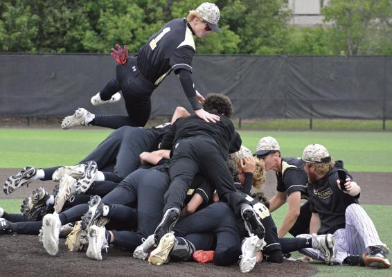 COOPER COLLINS braces himself to land on the celebratory dogpile following Excelsior Springs’ win over Oak Grove in the Class 4 District 15 Tournament championship game. Collins and his fellow Tigers were slated to play St. Michael the Archangel Thursday in the Class 4 state quarterfinals. SHAWN RONEY | Staff