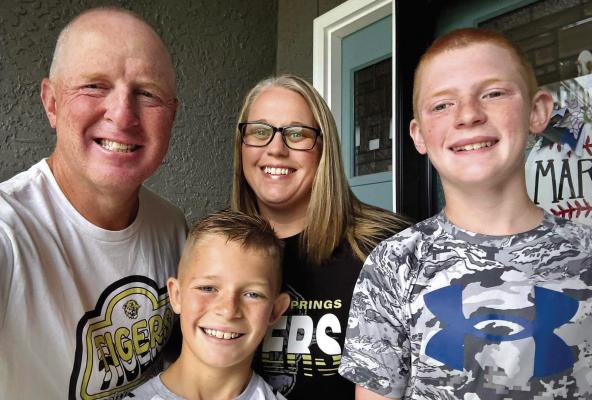 RICHIE (FROM LEFT), Carson, Andrea and Conner Marsh celebrate Andrea’s achievement of 23 years of dedication to Elkhorn Elementary students. MIRANDA JAMISON | Staff