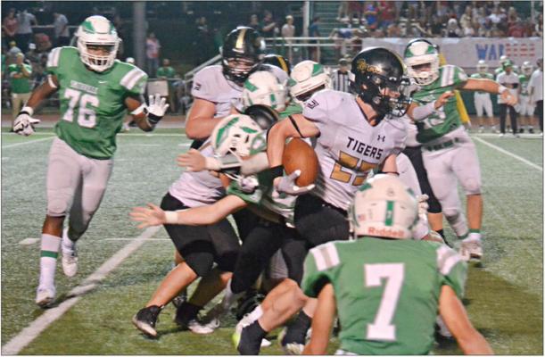 EXCELSIOR SPRINGS junior Dawson Claypole, with the football tucked under his right arm, finds a hole in the line and rushes for a big gain during the Tigers’ Sept. 22 Greater Kansas City Suburban Conference-Blue Division road meeting with top 10-ranked Smithville. DUSTIN DANNER | Staff