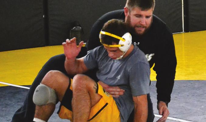 TIGERS WRESTLING coach Cody Beck demonstrates drills with returning state champion Ayden Dolt. DUSTIN DANNER | Staff