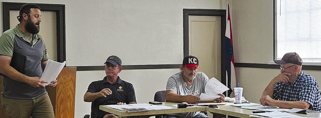 NATHANIEL BEEGHLY (left) addresses the Mosby Board of Aldermen during a recent meeting, voicing concerns about blasting, dust and sinkholes tied to a proposed annexation for mining. MIRANDA JAMISON | Staff