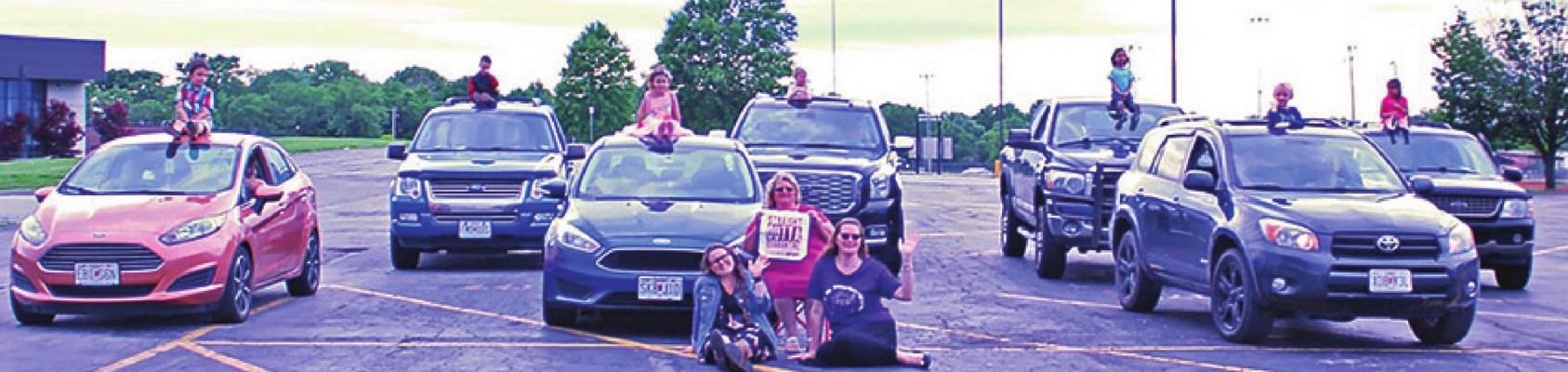 UNABLE TO TAKE a traditional classroom photo due to COVID-19, Noah’s Ark students take a photo in the Noah’s Ark Christian Preschool parking lot.