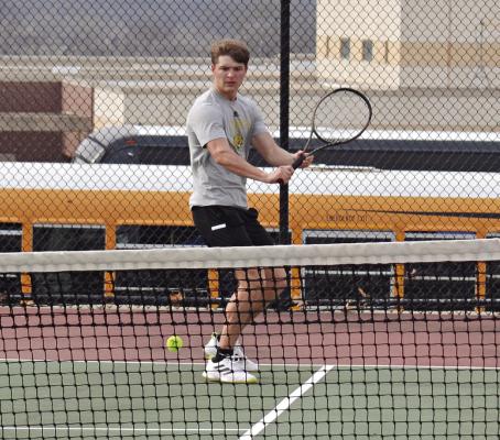 EXCELSIOR SPRINGS SENIOR Colby Mueller prepares to execute a backhand shot during an April 4 home varsity tennis dual with Harrisonville. DUSTIN DANNER | Staff